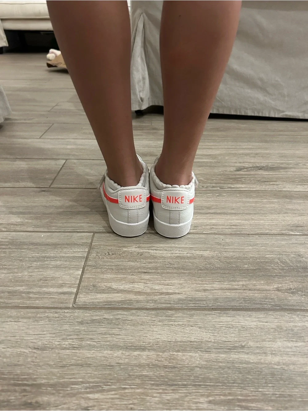 Nike Women’s White Sneakers with Coral Swoosh Accent